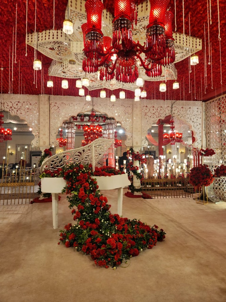 Lobby Entrance with White Grand Piano and Cascading Red Roses